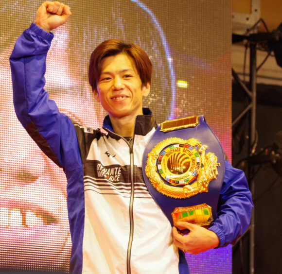 拳を上げる第1回王者・田村隆信